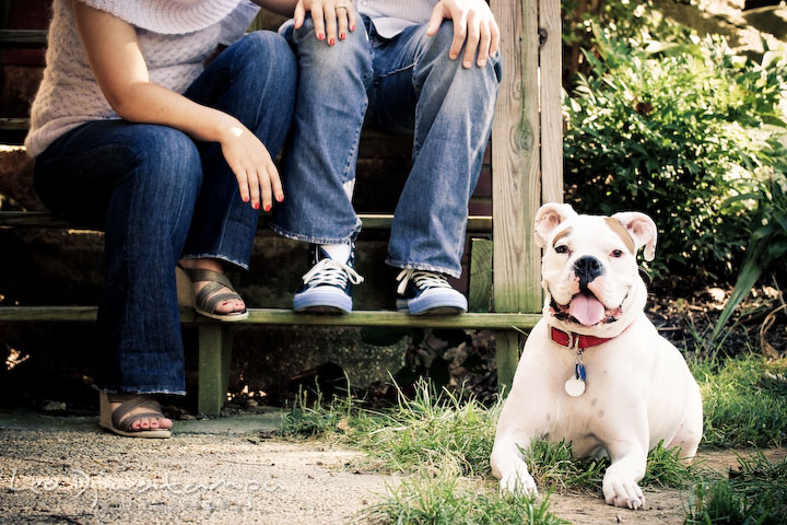 White boxer dog posing with the owner in the background. Candid Old Town Alexandria Virginia Engagement Photography Session by Wedding Photographer Leo Dj