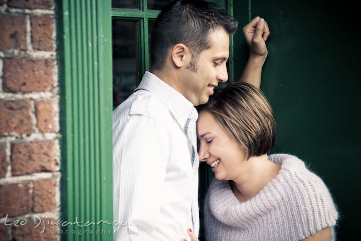 Engaged couple cuddling and laughing. Candid Old Town Alexandria Virginia Engagement Photography Session by Wedding Photographer Leo Dj