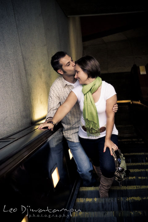 Engaged guy kissed his fiancee's forehead on escalator. Washington DC, Smithsonian, The Mall Pre-wedding Engagement Session Photographer Leo Dj Photography