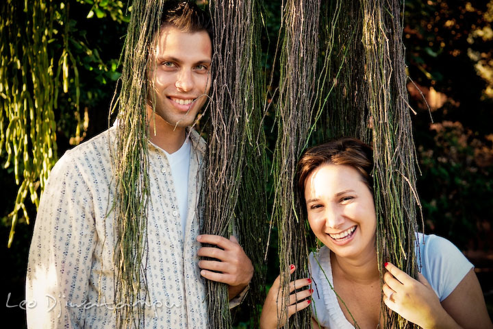 Engaged guy and girl wearing plants that looks like long hair. Washington DC, Smithsonian, The Mall Pre-wedding Engagement Session Photographer Leo Dj Photography