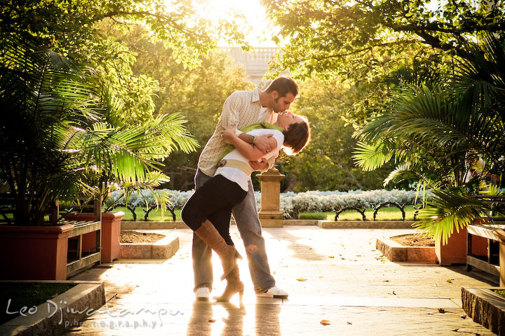 Engaged couple kissing, doing the dip, in the garden. Washington DC, Smithsonian, The Mall Pre-wedding Engagement Session Photographer Leo Dj Photography