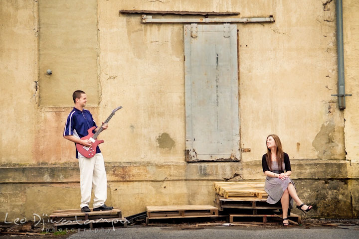 Engaged guy playing guitar to his fiancée. Pre-Wedding Engagement Photo Session at Sykesville Maryland with Train Rail and Caboose by wedding photographer Leo Dj Photography