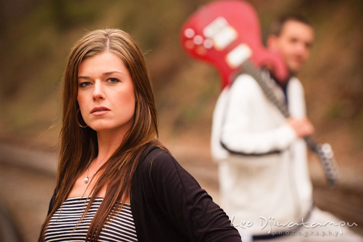 Engaged girl posing while her fiancé is in the background. Pre-Wedding Engagement Photo Session at Sykesville Maryland with Train Rail and Caboose by wedding photographer Leo Dj Photography