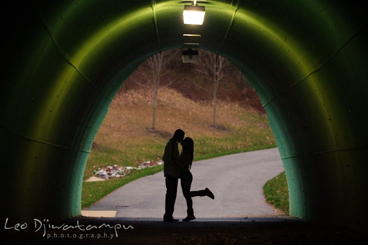 Engaged couple kissing in a tunnel. Pre-Wedding Engagement Photo Session at Sykesville Maryland with Train Rail and Caboose by wedding photographer Leo Dj Photography