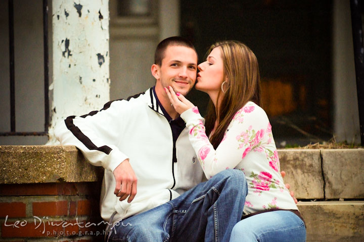 Engaged girl kissed her fiancé on the cheek. Pre-Wedding Engagement Photo Session at Sykesville Maryland with Train Rail and Caboose by wedding photographer Leo Dj Photography