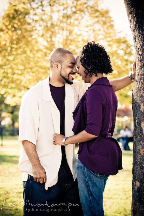 engaged couple standing, talking and laughing. Federal Hill Park Baltimore pre-wedding engagement portrait