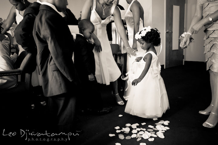 Flower girl spill flower petals on floor while others are getting ready. Wedding photography at Padonia Park Club at Towson, Timonium-Cockeysville area, North of Baltimore
