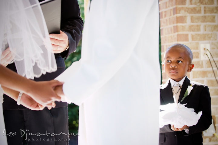 Ring bearer boy looking at bride and groom holding hands. Wedding photography at Padonia Park Club at Towson, Timonium-Cockeysville area, North of Baltimore