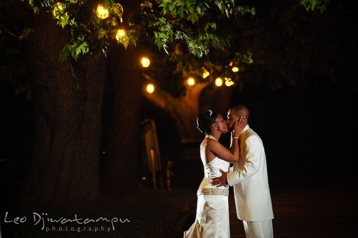 Bride and groom kissing under the evening lights. Wedding photography at Padonia Park Club at Towson, Timonium-Cockeysville area, North of Baltimore