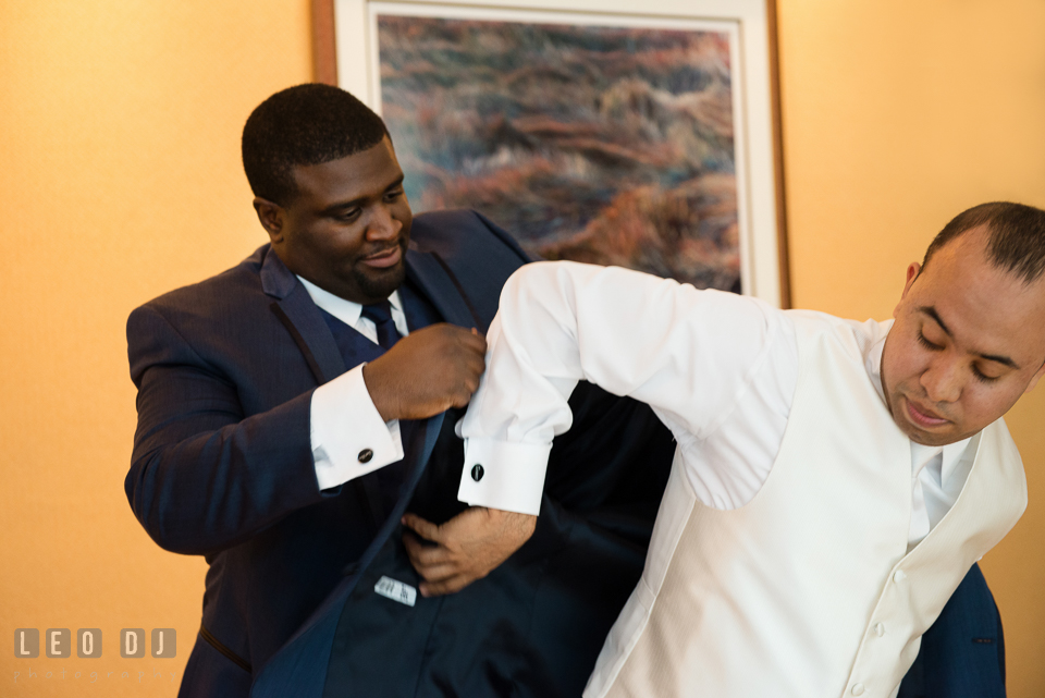 Best Man helps Groom put on tuxedo. Falls Church Virginia 2941 Restaurant wedding ceremony and reception photo, by wedding photographers of Leo Dj Photography. http://leodjphoto.com