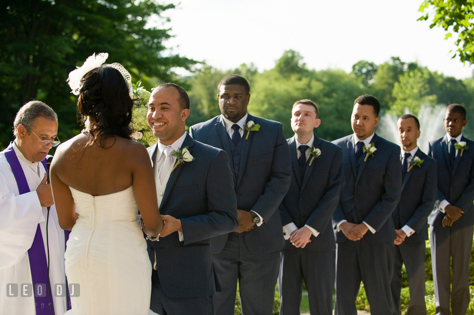 Groom smiling during the ceremony with groom's party in the background. Falls Church Virginia 2941 Restaurant wedding ceremony and reception photo, by wedding photographers of Leo Dj Photography. http://leodjphoto.com