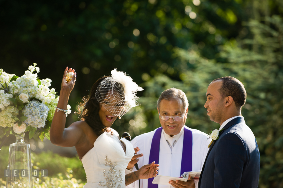 Bride happily showing off her box of gold coins during the wedding ceremony. Falls Church Virginia 2941 Restaurant wedding ceremony and reception photo, by wedding photographers of Leo Dj Photography. http://leodjphoto.com