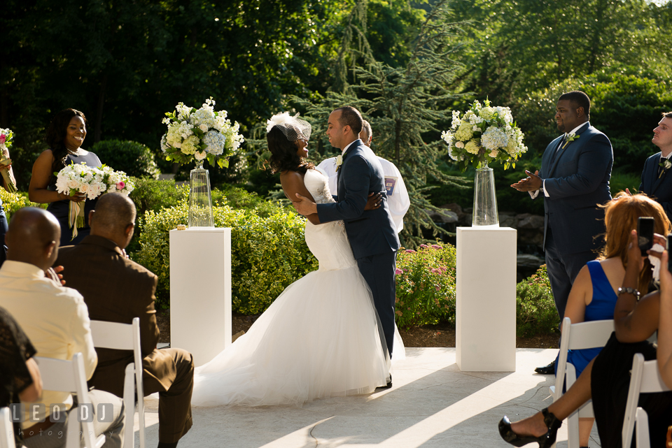 Groom trying to kiss the Bride during the ceremony. Falls Church Virginia 2941 Restaurant wedding ceremony and reception photo, by wedding photographers of Leo Dj Photography. http://leodjphoto.com