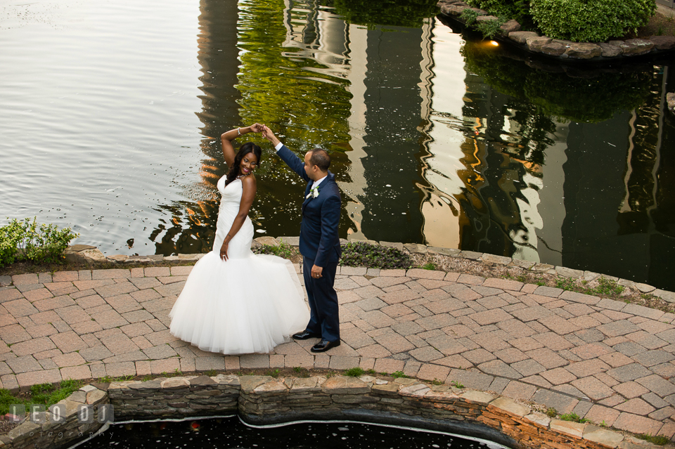 Groom dancing and twirling Bride by the pond. Falls Church Virginia 2941 Restaurant wedding ceremony and reception photo, by wedding photographers of Leo Dj Photography. http://leodjphoto.com