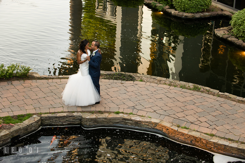 Slow dance by the pond with koi fishes before wedding reception. Falls Church Virginia 2941 Restaurant wedding ceremony and reception photo, by wedding photographers of Leo Dj Photography. http://leodjphoto.com