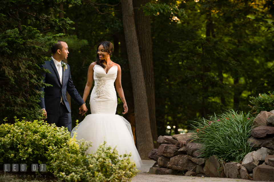 The Bride and Groom walking among the gardens. Falls Church Virginia 2941 Restaurant wedding ceremony and reception photo, by wedding photographers of Leo Dj Photography. http://leodjphoto.com