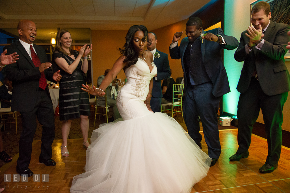 The Bride having fun dancing during the wedding reception cheered by the family. Falls Church Virginia 2941 Restaurant wedding ceremony and reception photo, by wedding photographers of Leo Dj Photography. http://leodjphoto.com