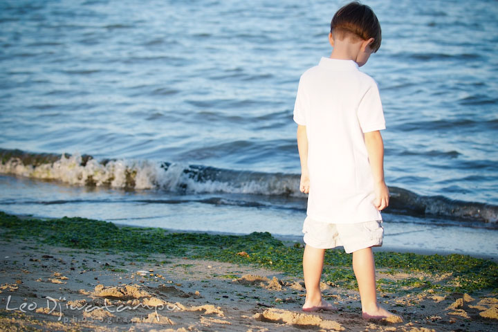 A boy looking at the blue water on the beach. Kent Island, Annapolis, MD Fun Candid Family Lifestyle Photographer, Leo Dj Photography