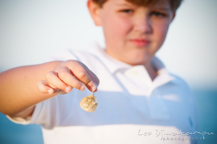 A kid, boy, showing a tiny horse shoe crab. Kent Island, Annapolis, MD Fun Candid Family Lifestyle Photographer, Leo Dj Photography