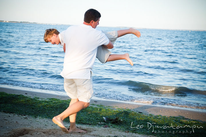 Father swingin his son, pretending going to throw him in the water. Kent Island, Annapolis, MD Fun Candid Family Lifestyle Photographer, Leo Dj Photography