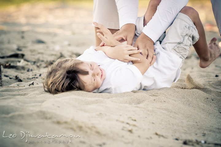 Mom tickling his son on the beach sand. Kent Island, Annapolis, MD Fun Candid Family Lifestyle Photographer, Leo Dj Photography