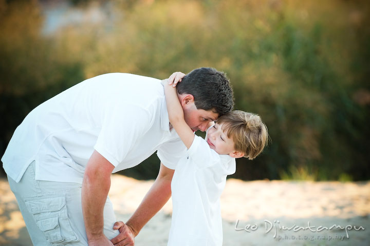 Son embracing dad's neck. Kent Island, Annapolis, MD Fun Candid Family Lifestyle Photographer, Leo Dj Photography