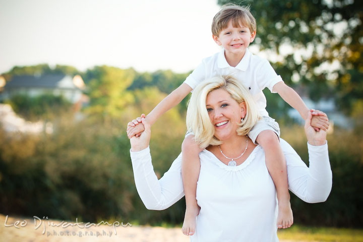 Mother carrying his son on her shoulder. Kent Island, Annapolis, MD Fun Candid Family Lifestyle Photographer, Leo Dj Photography