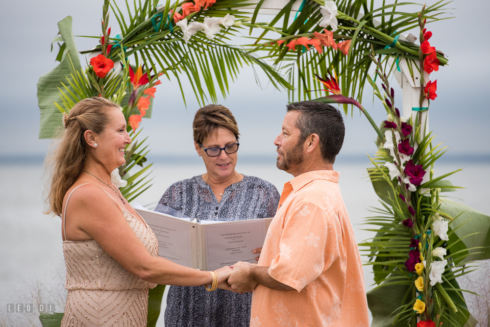 Silver Swan Bayside Groom put ring on Bride at wedding ceremony photo by Leo Dj Photography