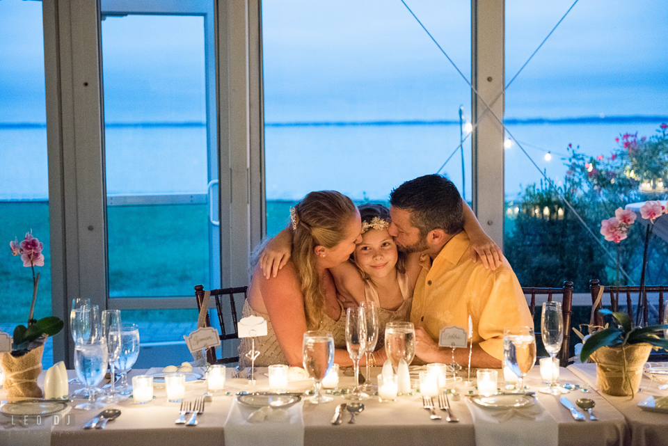 Silver Swan Bayside Groom and Bride kissed daughter by wedding reception table photo by Leo Dj Photography