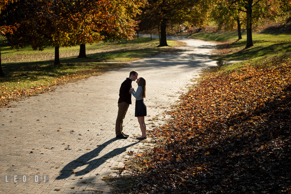 Patterson Park Baltimore Maryland engaged couple almost kissing on brick path photo by Leo Dj Photography.