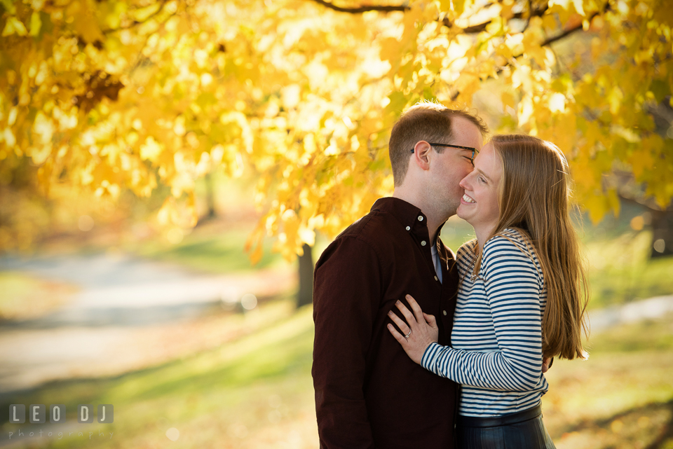 Patterson Park Baltimore Maryland engaged girl laughing as fiance kissed photo by Leo Dj Photography.