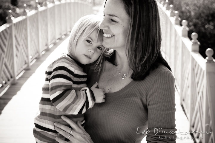 mother and her daughter by a bridge in a park. Fun candid family children lifestyle photographer Annapolis Maryland