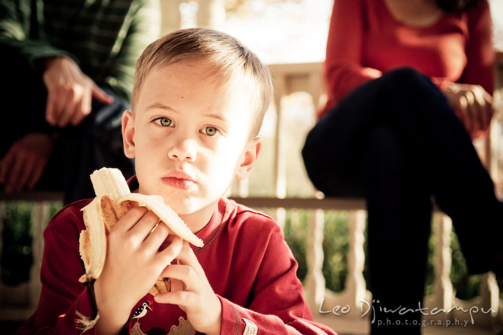 boy eating banana. Fun candid family children lifestyle photographer Annapolis Maryland