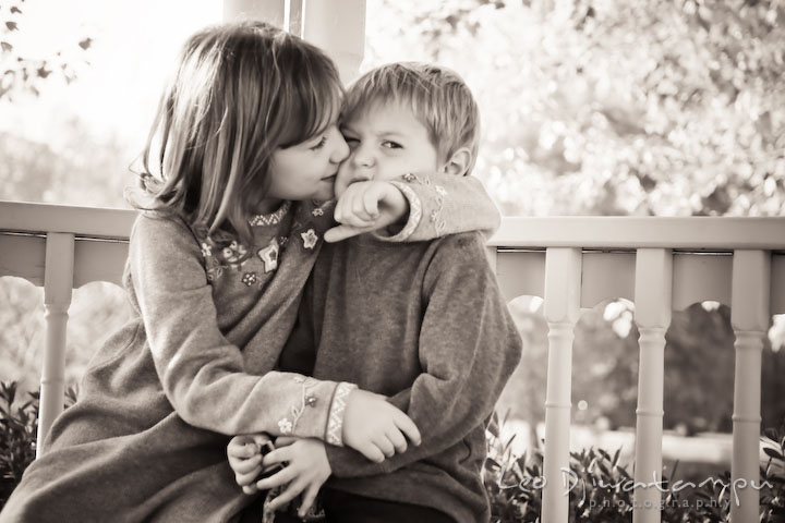 sister kissing brother. Fun candid family children lifestyle photographer Annapolis Maryland