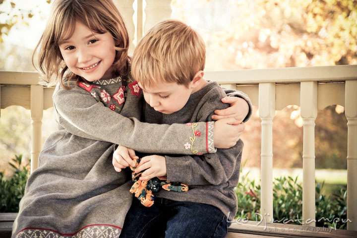 sister hugging brother. Fun candid family children lifestyle photographer Annapolis Maryland