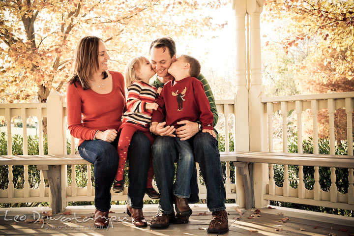 children, brother and sister kissing father. mom looking at dad. Fun candid family children lifestyle photographer Annapolis Maryland