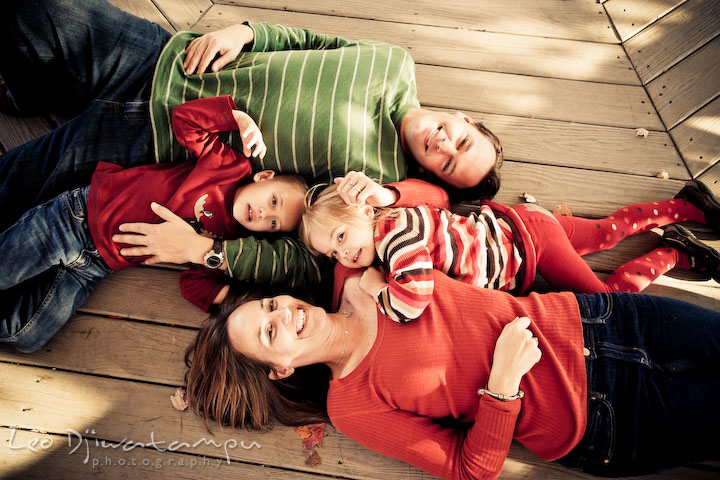 the whole family on the floor, smiling, laughing. Fun candid family children lifestyle photographer Annapolis Maryland