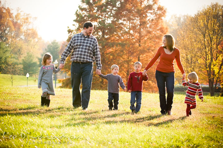 brother, sister, and children walking together holding hands. Fun candid family children lifestyle photographer Annapolis Maryland