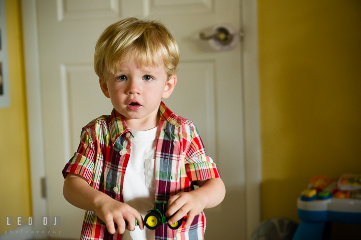 Little boy playing with his John Deere tractor. Queenstown, Eastern Shore Maryland candid children and family lifestyle portrait photo session by photographers of Leo Dj Photography. http://leodjphoto.com