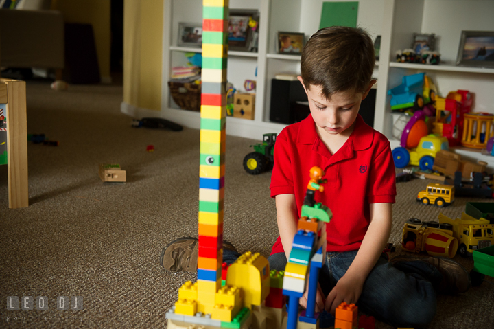 Toddler boy playing Lego Duplo in the basement. Queenstown, Eastern Shore Maryland candid children and family lifestyle portrait photo session by photographers of Leo Dj Photography. http://leodjphoto.com