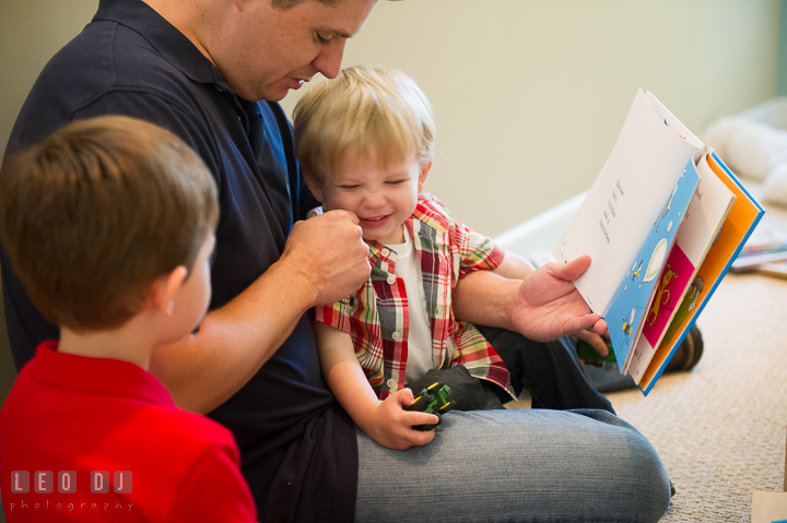 Boys reading books together and laughing with their Father. Queenstown, Eastern Shore Maryland candid children and family lifestyle portrait photo session by photographers of Leo Dj Photography. http://leodjphoto.com