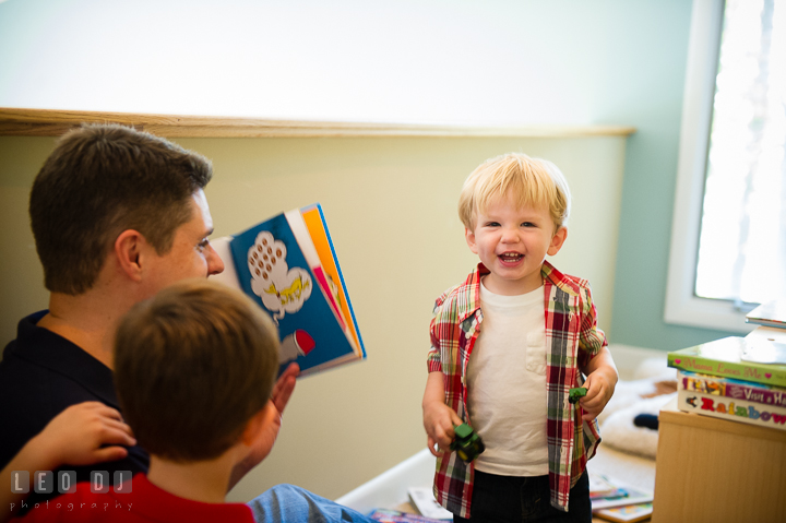 Little boy laughing as Dad reads book to him. Queenstown, Eastern Shore Maryland candid children and family lifestyle portrait photo session by photographers of Leo Dj Photography. http://leodjphoto.com