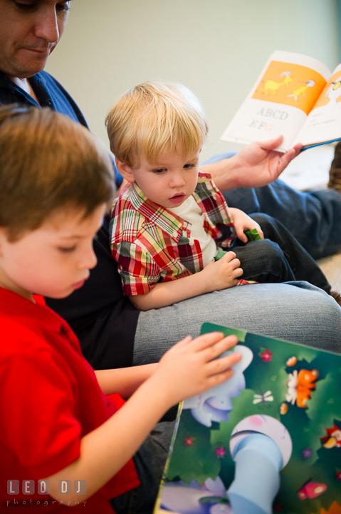 Little boy curious to see what his big brother is reading. Queenstown, Eastern Shore Maryland candid children and family lifestyle portrait photo session by photographers of Leo Dj Photography. http://leodjphoto.com