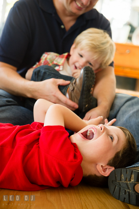 Dad and his sons playing and laughing together. Queenstown, Eastern Shore Maryland candid children and family lifestyle portrait photo session by photographers of Leo Dj Photography. http://leodjphoto.com