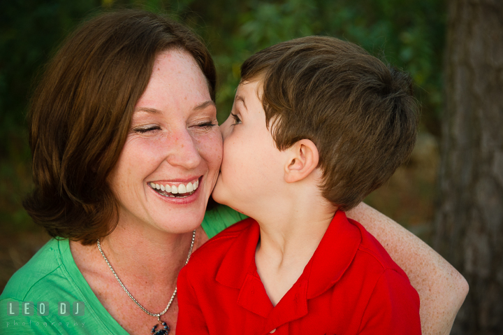 Toddler boy kissing his Mom's cheek. Queenstown, Eastern Shore Maryland candid children and family lifestyle portrait photo session by photographers of Leo Dj Photography. http://leodjphoto.com