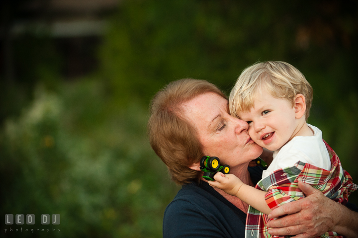 Grandmother kissing her youngest grandson. Queenstown, Eastern Shore Maryland candid children and family lifestyle portrait photo session by photographers of Leo Dj Photography. http://leodjphoto.com