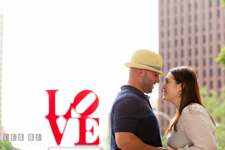 Engaged couple smiling together. Pre-wedding or engagement photo session at Phillies Ball Park, Love Park, Philadelphia, by wedding photographers of Leo Dj Photography.