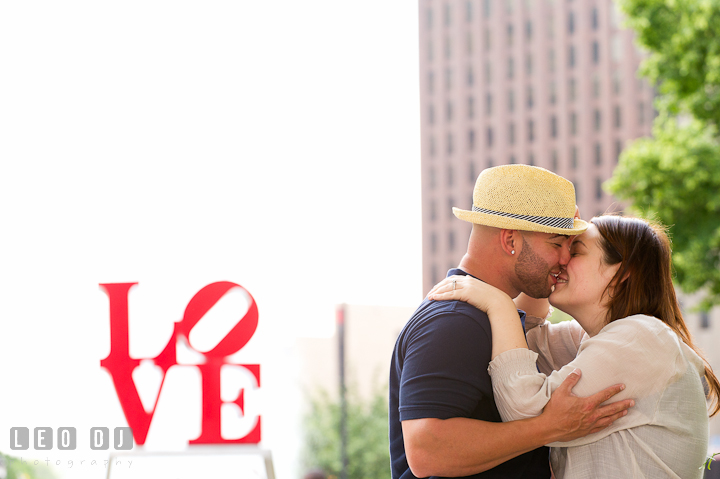 Engaged couple almost kissed. Pre-wedding or engagement photo session at Phillies Ball Park, Love Park, Philadelphia, by wedding photographers of Leo Dj Photography.