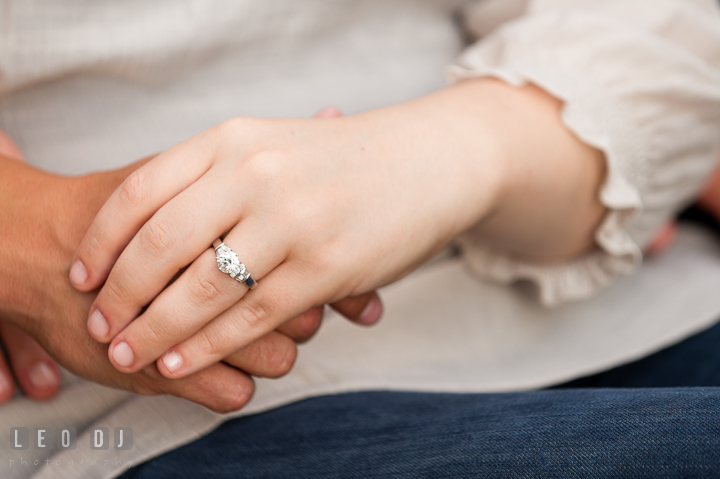 Engaged couple holding hands, showing the diamond engagement ring. Pre-wedding or engagement photo session at Phillies Ball Park, Love Park, Philadelphia, by wedding photographers of Leo Dj Photography.