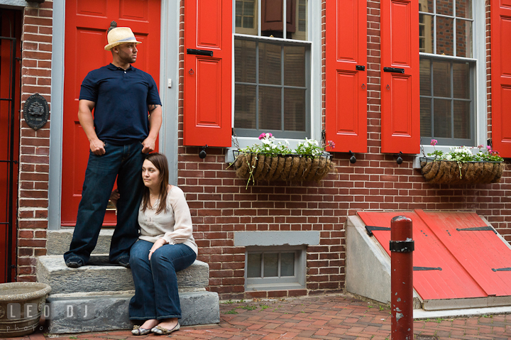 Engaged guy and his fiancée posing at Elfreth's Alley. Pre-wedding or engagement photo session at Phillies Ball Park, Love Park, Philadelphia, by wedding photographers of Leo Dj Photography.